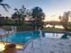 Outdoor swimming pool with scenic waterfront views, and palm trees perfect for a relaxing swim at 4438 Meager Cir, Port Charlotte, FL 33948