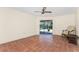 Bright sunroom with terra cotta tile, ceiling fan, and sliding glass doors opening to the pool area at 4438 Meager Cir, Port Charlotte, FL 33948