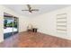 Bright sunroom with terra cotta tile, ceiling fan, and sliding glass doors opening to the outside at 4438 Meager Cir, Port Charlotte, FL 33948