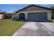 Charming single-Gathering home featuring an attached two-car garage and a well-maintained front lawn at 509 Beal Nw St, Port Charlotte, FL 33952