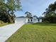 Charming single-Gathering home with a well-manicured lawn and attached two-car garage at 5097 Wagon Wheel Dr, North Port, FL 34291