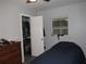 Small bedroom featuring a closet and dresser, with a bright window at 523 Oliphant Ln, Punta Gorda, FL 33950