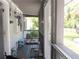 Cozy screened-in porch featuring a comfortable dog bed, water bowls, and relaxing outdoor space at 523 Oliphant Ln, Punta Gorda, FL 33950