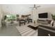 Open concept living space featuring a seamless layout, modern furnishings, tile floors, and access to a kitchen at 5354 Wagon Wheel Dr, North Port, FL 34291