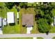 Overhead aerial view of property featuring home and surrounding greenery at 551 Crandall Nw St, Port Charlotte, FL 33952