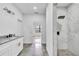 Bathroom featuring a double vanity with granite countertops and a walk-in shower at 551 Crandall Nw St, Port Charlotte, FL 33952
