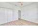 Bright bedroom with wood-look flooring, a ceiling fan, and closet at 551 Crandall Nw St, Port Charlotte, FL 33952