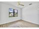 Bright bedroom with wood-look flooring and a ceiling fan at 551 Crandall Nw St, Port Charlotte, FL 33952