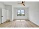 A bright bedroom with wood-look floors, a window, and a ceiling fan at 551 Crandall Nw St, Port Charlotte, FL 33952