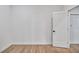 Bright bedroom with wood-look flooring, white walls, and a closet at 551 Crandall Nw St, Port Charlotte, FL 33952