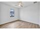 Bright bedroom featuring wood-look floors and a window view at 551 Crandall Nw St, Port Charlotte, FL 33952