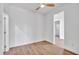 Bedroom with wood-look flooring, white walls, and a ceiling fan at 551 Crandall Nw St, Port Charlotte, FL 33952