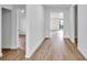 Bright hallway with wood-look flooring leading to various rooms at 551 Crandall Nw St, Port Charlotte, FL 33952