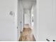 Bright hallway with wood-look flooring and white walls leading to other rooms in the home at 551 Crandall Nw St, Port Charlotte, FL 33952