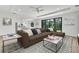 Open-concept living room featuring a sectional sofa and large windows at 551 Crandall Nw St, Port Charlotte, FL 33952