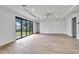Bright, airy living room with wood floors, ceiling fan, and sliding glass doors to the backyard at 551 Crandall Nw St, Port Charlotte, FL 33952