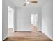 Open living room with wood-look flooring, white walls, and modern ceiling fan at 551 Crandall Nw St, Port Charlotte, FL 33952