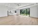 Open-concept living room features light wood floors, large sliding glass doors, and recessed lighting at 551 Crandall Nw St, Port Charlotte, FL 33952