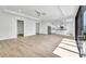 Bright living room boasts light wood floors and an open floor plan, blending modern style and comfort at 551 Crandall Nw St, Port Charlotte, FL 33952