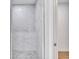 Shower featuring stylish marble-look tile and a stone-look floor at 551 Crandall Nw St, Port Charlotte, FL 33952