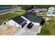 Scenic aerial perspective of a home highlighting its driveway, garage, dark roof, and proximity to the road at 5705 44Th E Ave, Bradenton, FL 34203