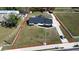 Aerial view of the property including the building outline with surrounding yard and driveway at 5705 44Th E Ave, Bradenton, FL 34203