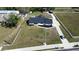 An aerial view of a house surrounded by a white fence and a large lawn with a paved driveway at 5705 44Th E Ave, Bradenton, FL 34203