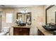 Well-lit bathroom with double decorative vessel sinks and marble-tiled walls at 5705 44Th E Ave, Bradenton, FL 34203