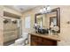 Luxurious bathroom featuring a walk-in shower, decorative vessel sink, and designer mirror at 5705 44Th E Ave, Bradenton, FL 34203