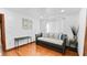 This bedroom features hardwood floors, white walls, a large closet and a gray daybed couch at 5705 44Th E Ave, Bradenton, FL 34203