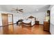 This is a spacious bedroom with hardwood floors, and a ceiling fan at 5705 44Th E Ave, Bradenton, FL 34203