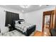 Bedroom showcasing dark grey accents, checkered bedspread, and plush rug at 5705 44Th E Ave, Bradenton, FL 34203