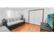 This bedroom boasts hardwood floors, white walls, a large closet and a gray daybed couch at 5705 44Th E Ave, Bradenton, FL 34203