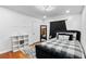 Bedroom featuring dark curtains, a checkered bedspread, and a white shelving unit at 5705 44Th E Ave, Bradenton, FL 34203