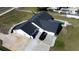 Aerial view of home featuring a dark roof, an attached garage, an in-ground pool and a paved driveway at 5705 44Th E Ave, Bradenton, FL 34203