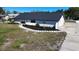 Single-story home with an attached garage, dark roof, and a horseshoe driveway with landscaping at 5705 44Th E Ave, Bradenton, FL 34203