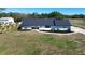 Charming single-story home with a dark roof and landscaped front yard with decorative stone walkway at 5705 44Th E Ave, Bradenton, FL 34203