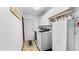 Well-organized laundry room with a modern washer and dryer, ample storage cabinets, and a convenient exterior access door at 5705 44Th E Ave, Bradenton, FL 34203