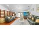 Open living area with hardwood floors, built-in shelving, and sliding glass doors, offering natural light and stylish decor at 5705 44Th E Ave, Bradenton, FL 34203