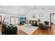 Bright living room with vaulted ceilings, modern lighting, and comfortable seating on wood floor, enhancing a spacious feel at 5705 44Th E Ave, Bradenton, FL 34203