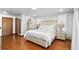 Elegant bedroom with hardwood floors, plush bedding, and natural light, creating a serene and inviting space for relaxation at 5705 44Th E Ave, Bradenton, FL 34203