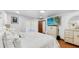 Bright bedroom with a comfortable bed, dresser, TV, and access to outdoor patio at 5705 44Th E Ave, Bradenton, FL 34203