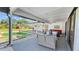 Covered patio featuring comfortable seating, providing a shaded retreat with a view of the pool and backyard at 5705 44Th E Ave, Bradenton, FL 34203