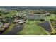 Aerial view of a community showcasing lush golf courses, serene lakes, and beautiful homes at 5733 White Jasmine Way, North Port, FL 34287