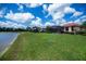 Expansive backyard with serene lake views, showcasing the property's outdoor space and waterfront appeal at 5733 White Jasmine Way, North Port, FL 34287