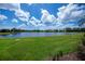Lush green backyard with a serene lake view, perfect for outdoor enjoyment at 5733 White Jasmine Way, North Port, FL 34287