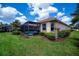 Backyard view showing a screened lanai, lush lawn, and well-maintained landscaping at 5733 White Jasmine Way, North Port, FL 34287