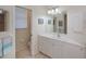 Bright bathroom with a walk-in shower, white vanity and lots of natural light at 5733 White Jasmine Way, North Port, FL 34287