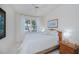 Bright bedroom featuring white tile floors and a side table at 5733 White Jasmine Way, North Port, FL 34287