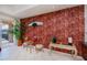 Cozy breakfast nook with a glass table, wallpapered accent wall, and sliding glass doors to the patio at 5733 White Jasmine Way, North Port, FL 34287